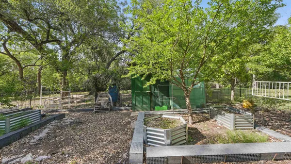 a swimming pool with trees in the background