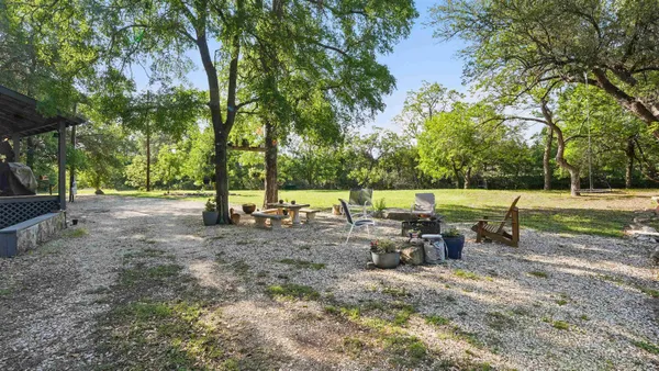 a backyard of a house with table and chairs