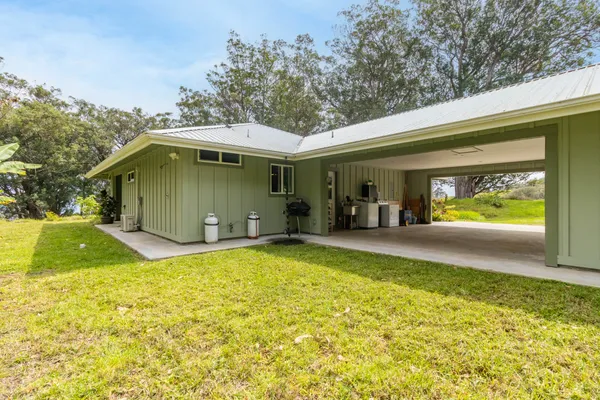 a view of a house with a backyard