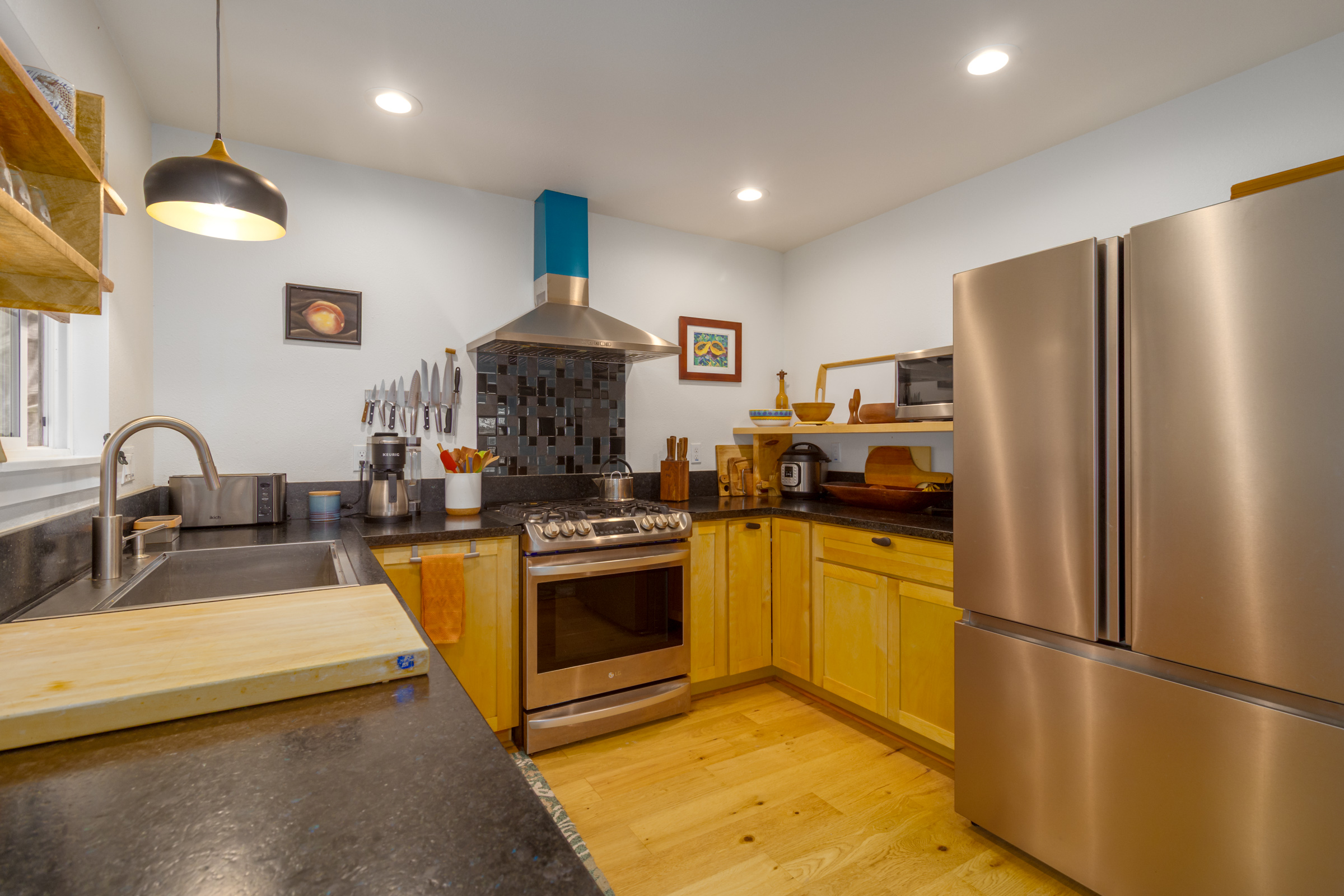 43-2114 Pohakea Mauka Road Paauilo, HI 96776 - Photo 10 of 30 a kitchen with stainless steel appliances granite countertop a refrigerator a stove a sink and a microwave