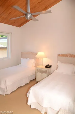 a bedroom with a bed and a night stand