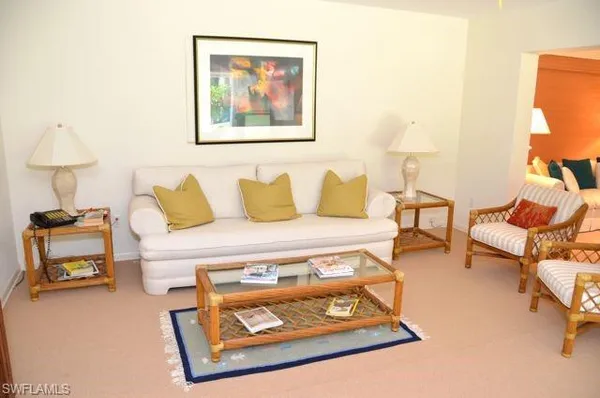 a living room with furniture and a lamp