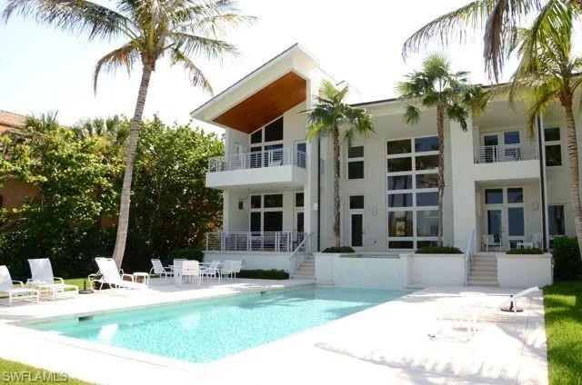 a view of a house with backyard and sitting area