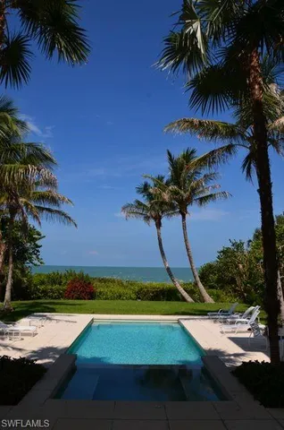 a view of a swimming pool with an outdoor space and seating area