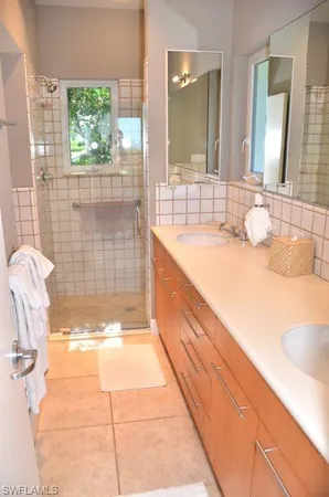 a bathroom with a tub sink and mirror