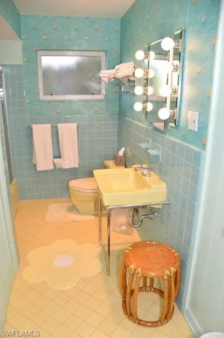 a bathroom with a sink mirror and vanity