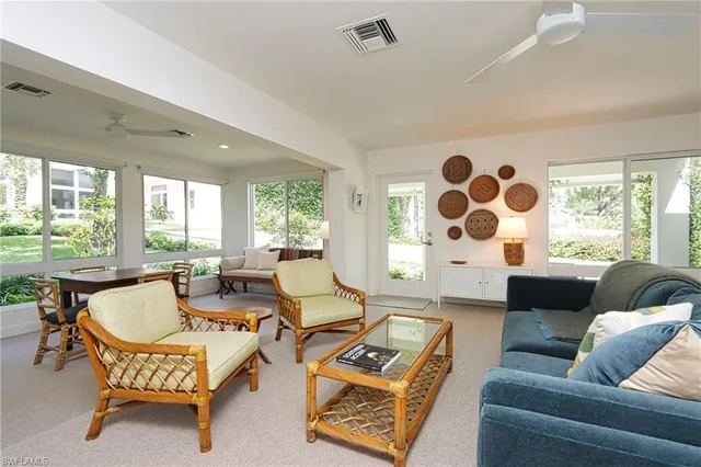 a living room with furniture and a floor to ceiling window