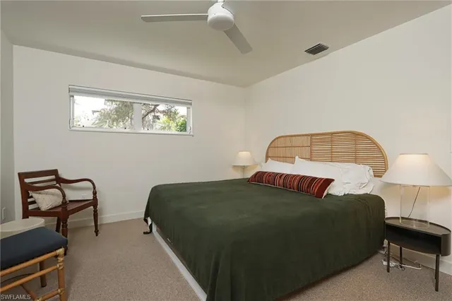 a bedroom with a bed chair and window