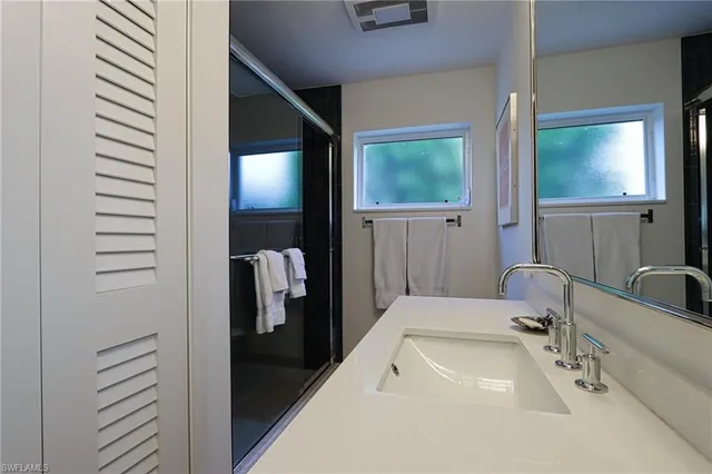 a bathroom with a sink and mirror