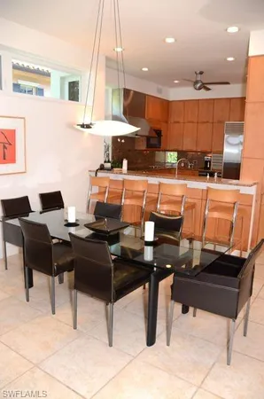 a view of a kitchen with kitchen island stainless steel appliances a sink and counter space