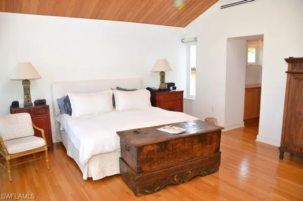 a bedroom with a bed and a table