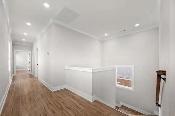 a view of hallway with wooden floor