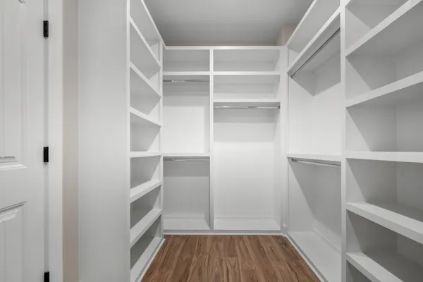a view of walk in closet with empty racks