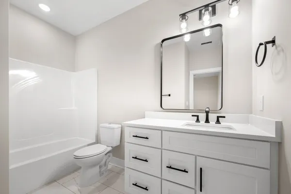 a bathroom with a toilet a sink and a bathtub