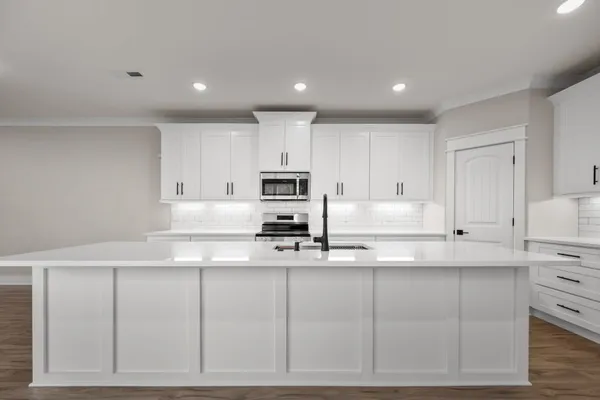 a kitchen with cabinets and stainless steel appliances
