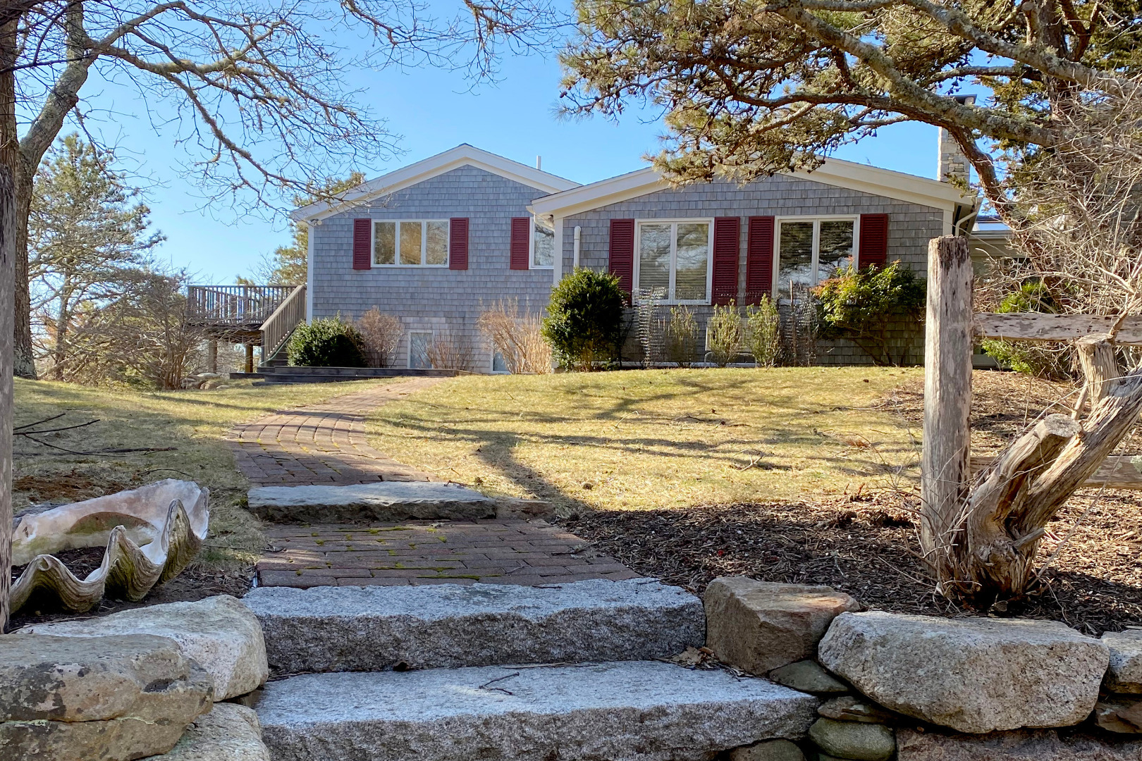 a view of a house with backyard and sitting area