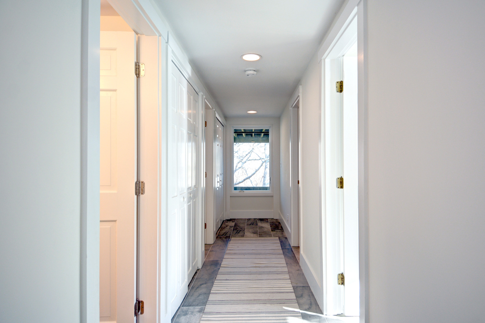 1 Smith Lane Chilmark, MA 02535 - Photo 17 of 27 a view of a hallway with a livingroom and a bathroom with a sink
