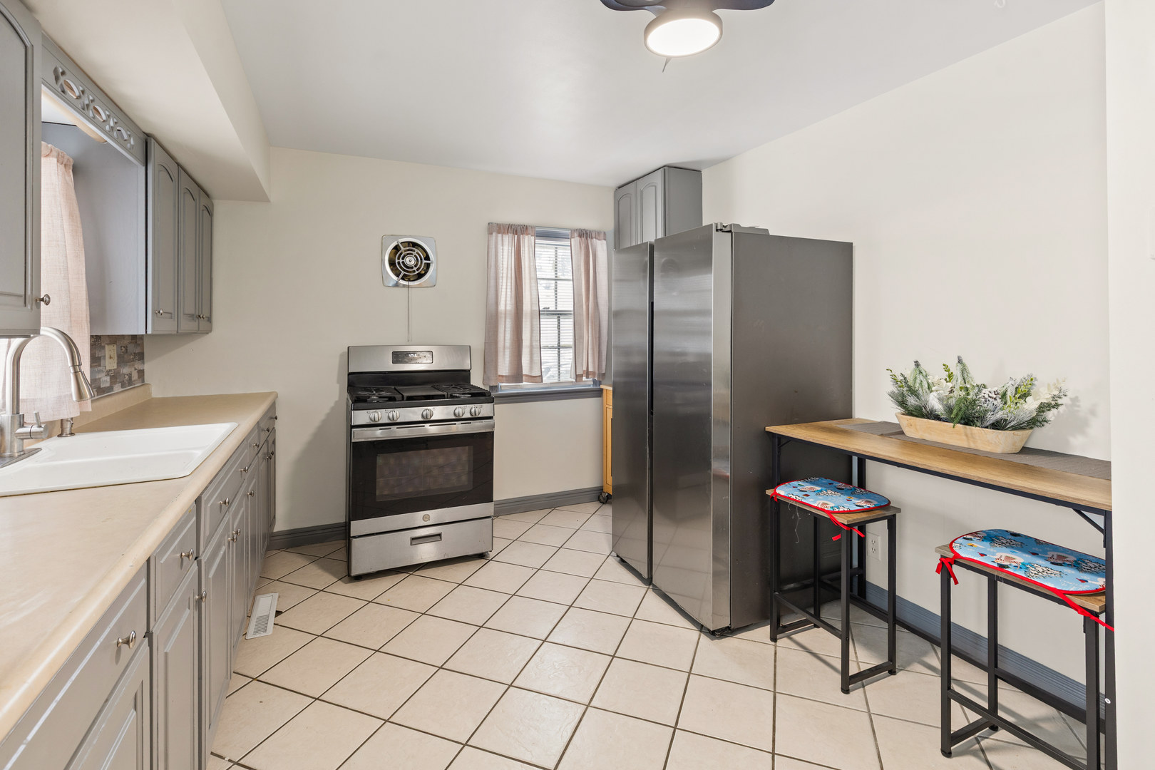 1340 Lennington Circle Northeast Kankakee, IL 60901 - Photo 8 of 25 a kitchen with stainless steel appliances a stove a sink and a refrigerator