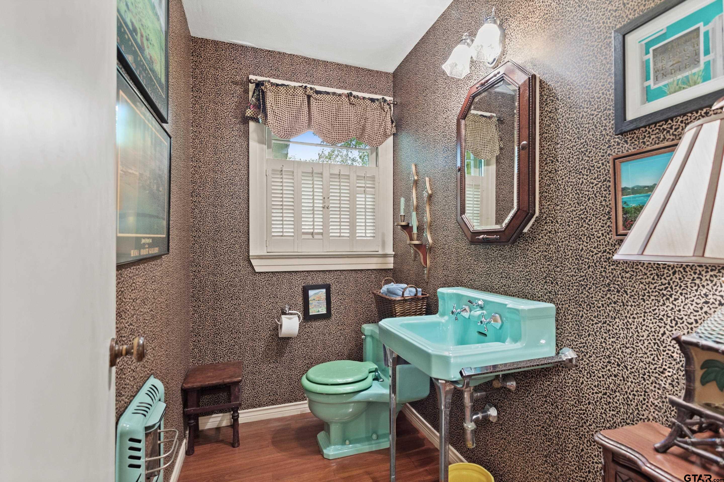 2631 Old Bullard Road Tyler, TX 75701 - Photo 31 of 43 a bathroom with a sink a mirror and a toilet