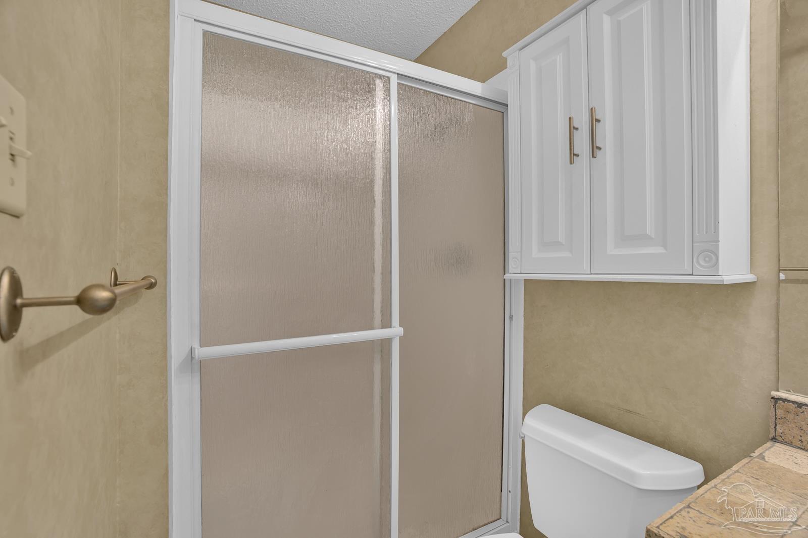 5036 Hamilton Lane Pace, FL 32571 - Photo 13 of 37 a white toilet sitting next to a bathroom sink