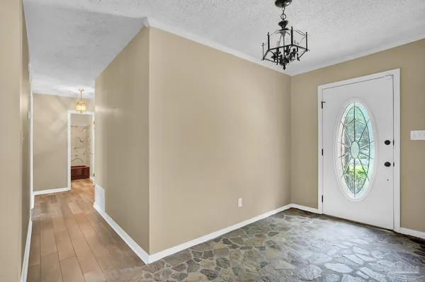 a view of a hallway with a wooden floor and entryway