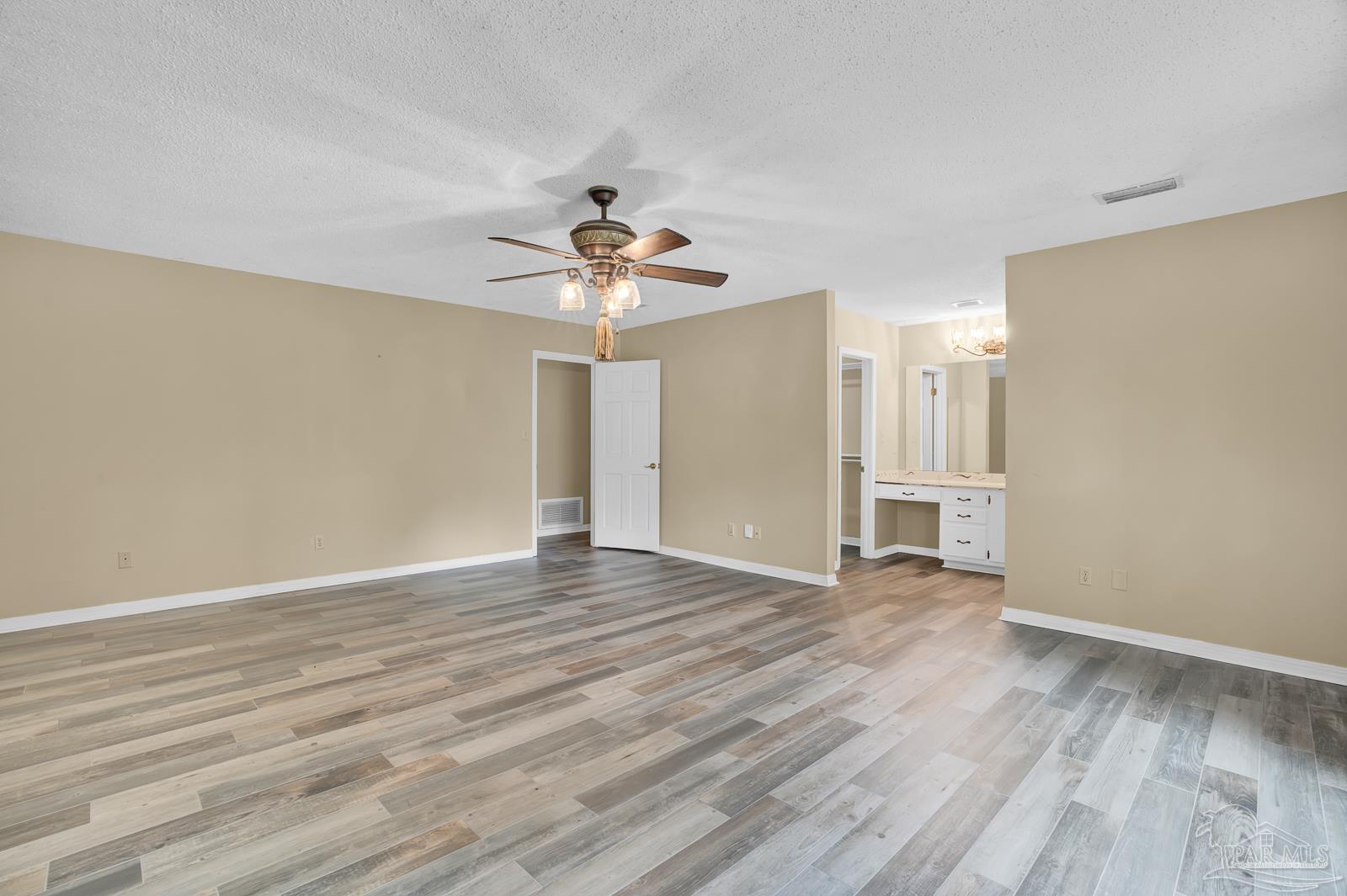 5036 Hamilton Lane Pace, FL 32571 - Photo 18 of 37 a view of an empty room with wooden floor