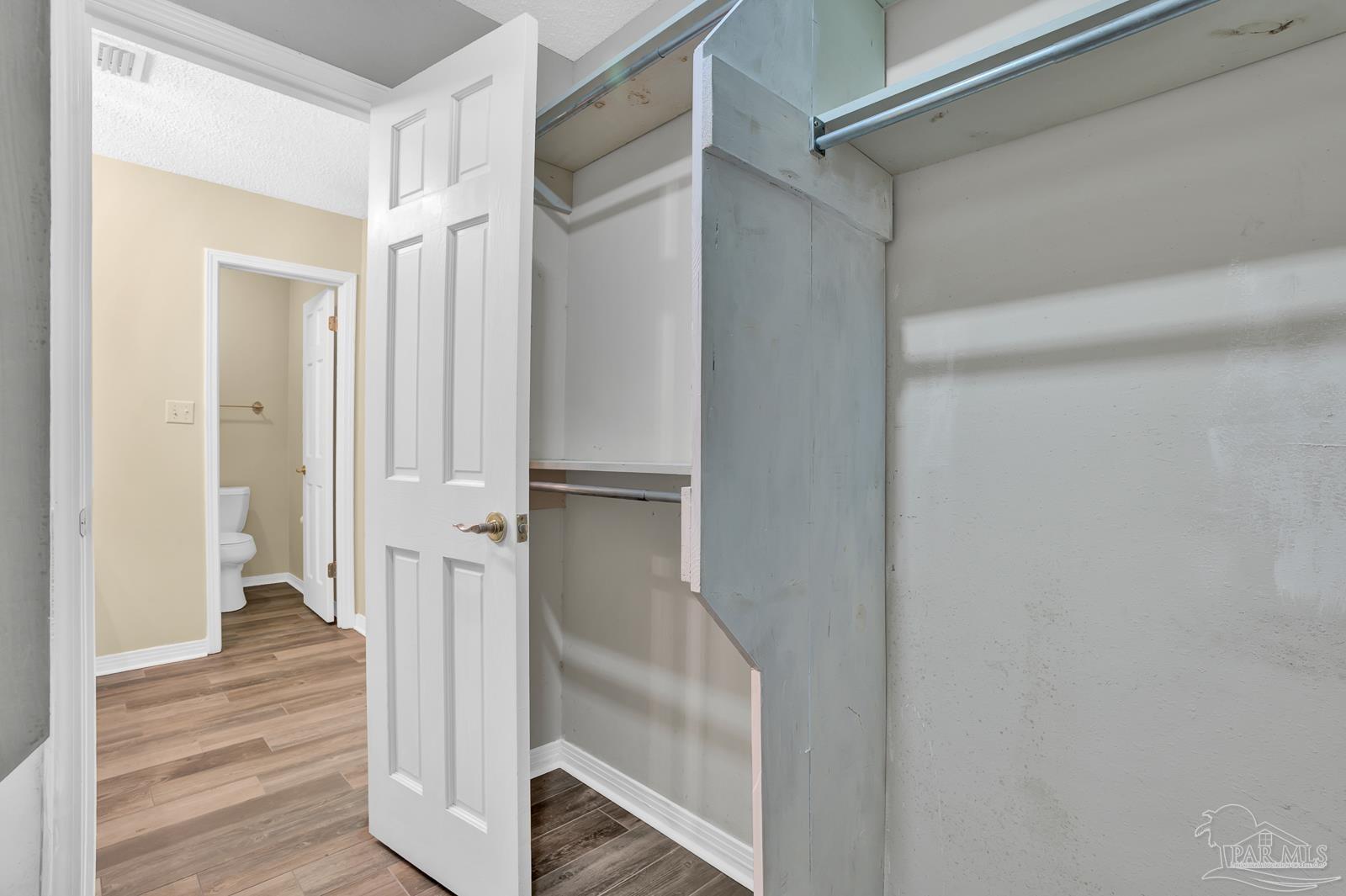 5036 Hamilton Lane Pace, FL 32571 - Photo 21 of 37 a view of a hallway with a wooden floor and entryway