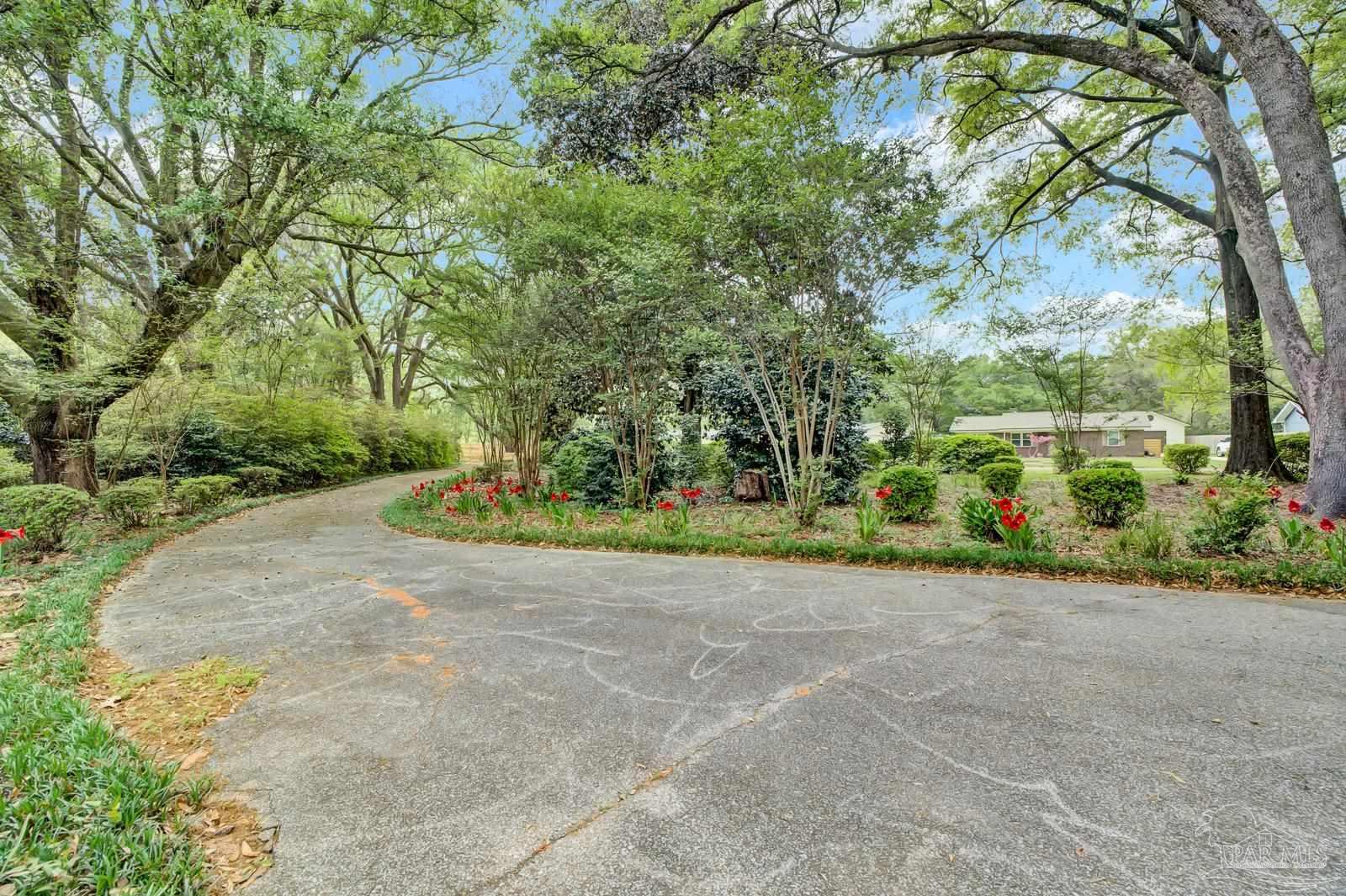 5036 Hamilton Lane Pace, FL 32571 - Photo 35 of 37 a view of a garden with plants
