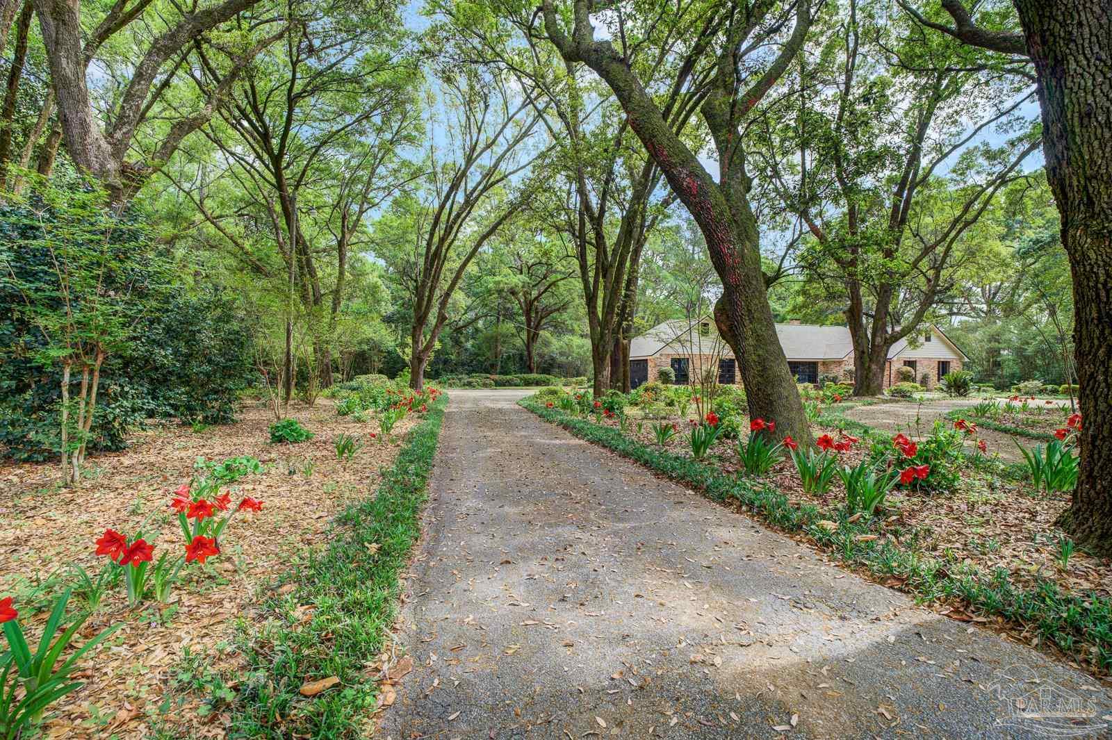 5036 Hamilton Lane Pace, FL 32571 - Photo 37 of 37 a park view with potted plants and large trees