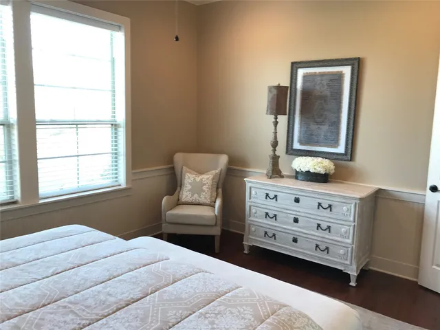a bedroom with a bed and a dresser