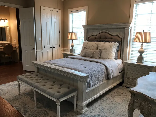 a bedroom with a bed a table and chair