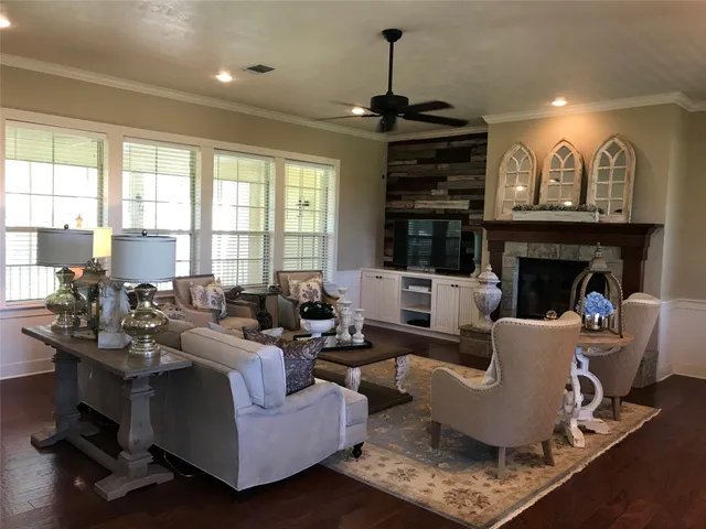 a living room with furniture a fireplace and a chandelier