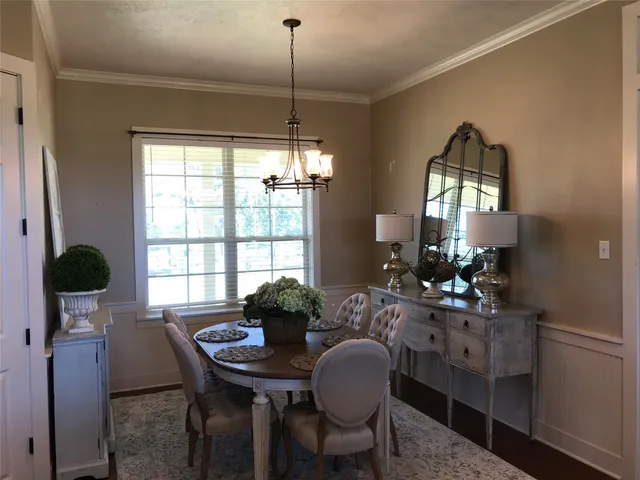 a view of a dining room with furniture and chandelier