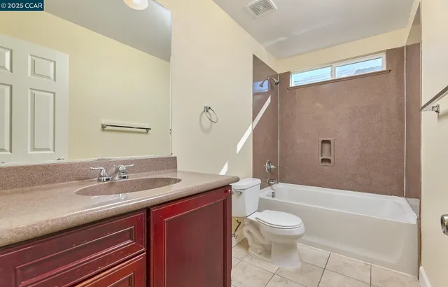 a bathroom with a granite countertop sink toilet a large mirror a bathtub and shower