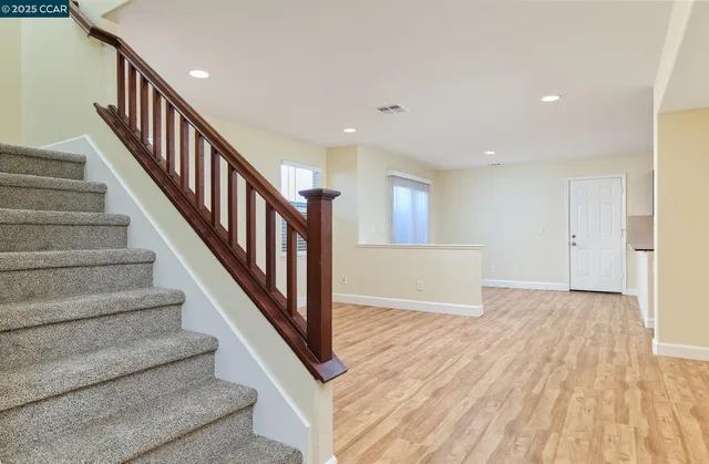 a view of an entryway with wooden floor