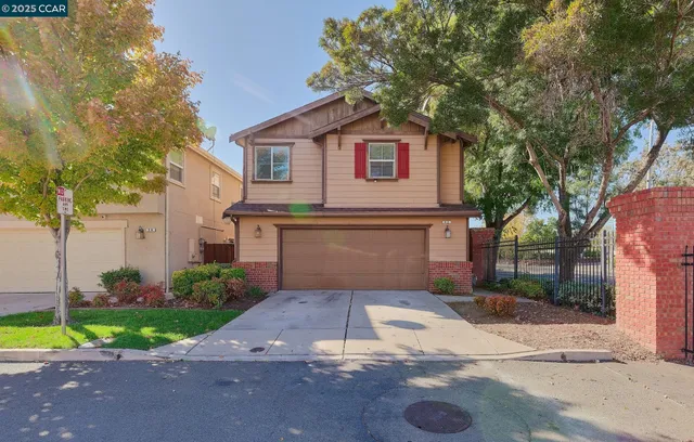 a front view of a house with a yard and a garage