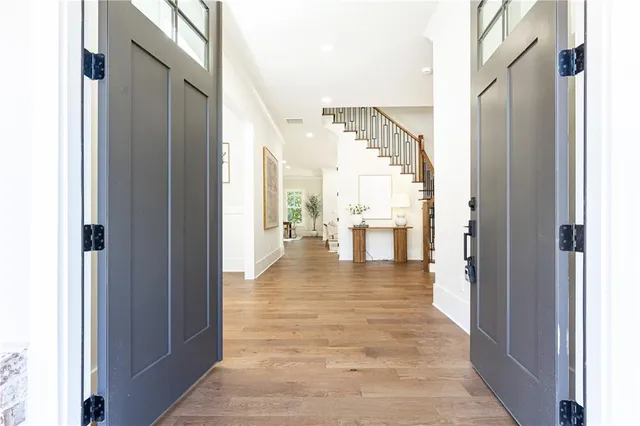 a view of entryway and hall with wooden floor