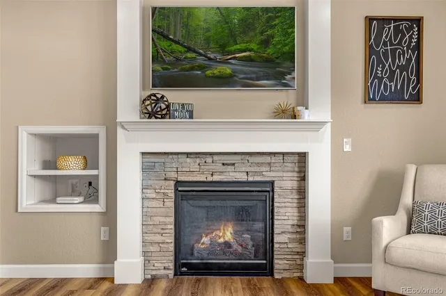 a living room with a fireplace and a wooden floor