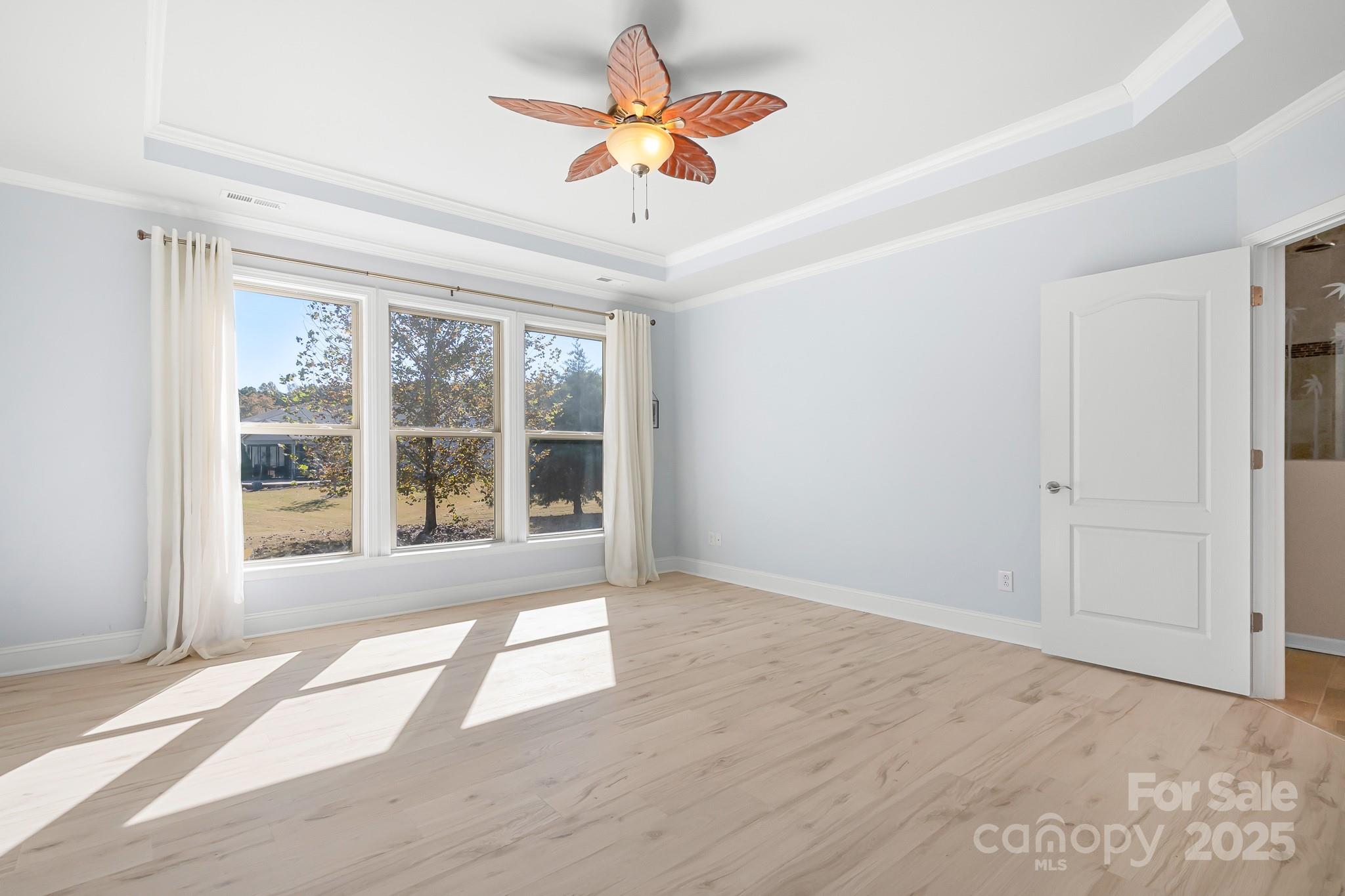 910 Kirby Drive Fort Mill, SC 29715 - Photo 15 of 30 a view of an empty room with a window and a ceiling fan