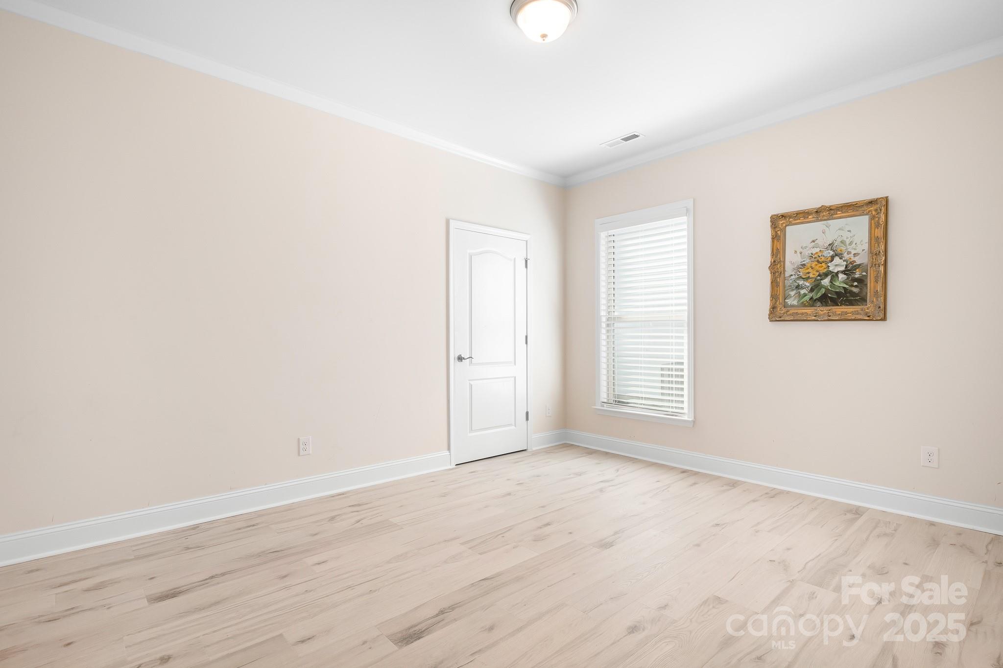 910 Kirby Drive Fort Mill, SC 29715 - Photo 18 of 30 an empty room with wooden floor and windows
