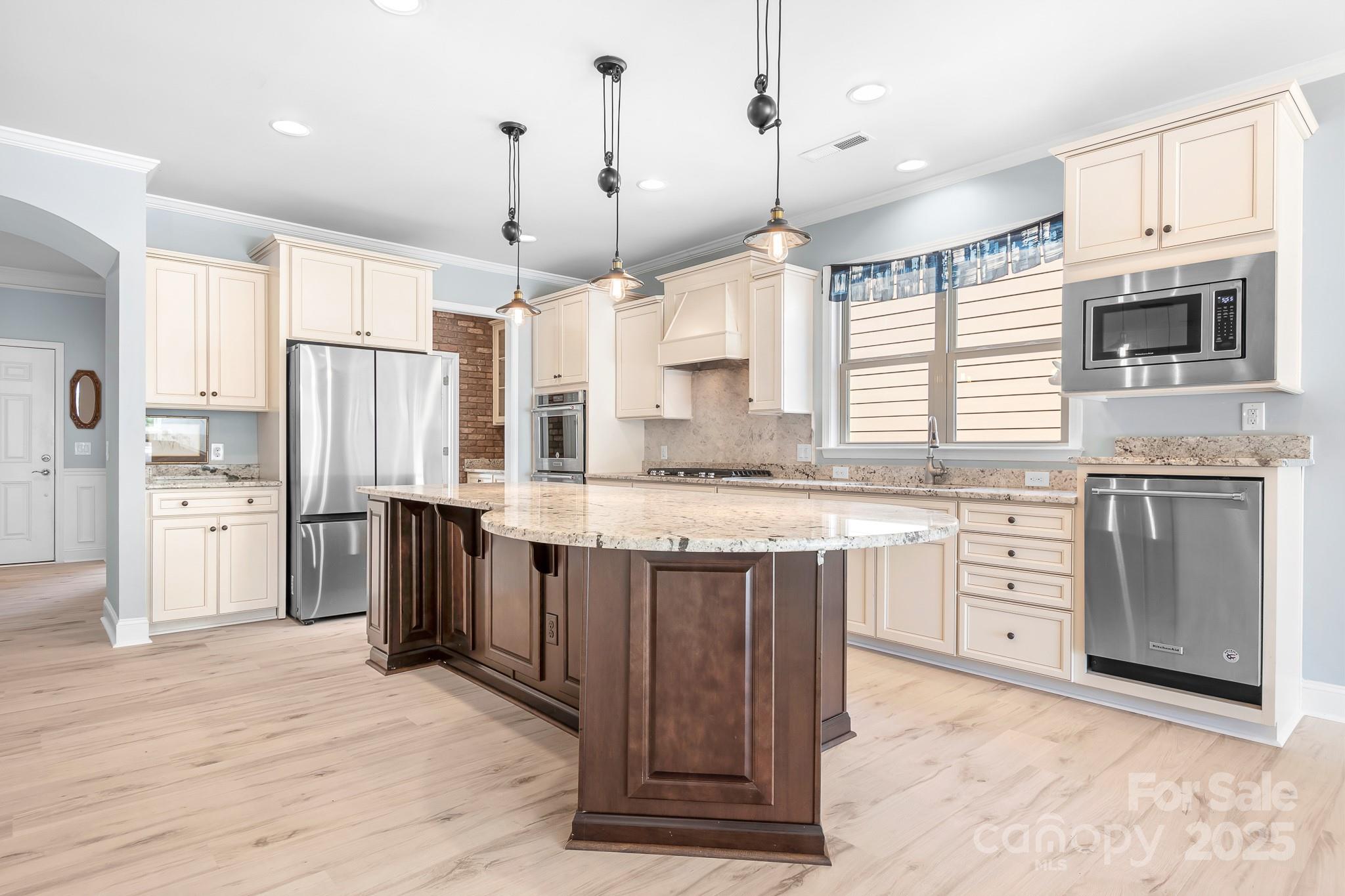 910 Kirby Drive Fort Mill, SC 29715 - Photo 3 of 30 a kitchen with stainless steel appliances granite countertop a refrigerator a sink dishwasher a stove and white countertops with wooden floor