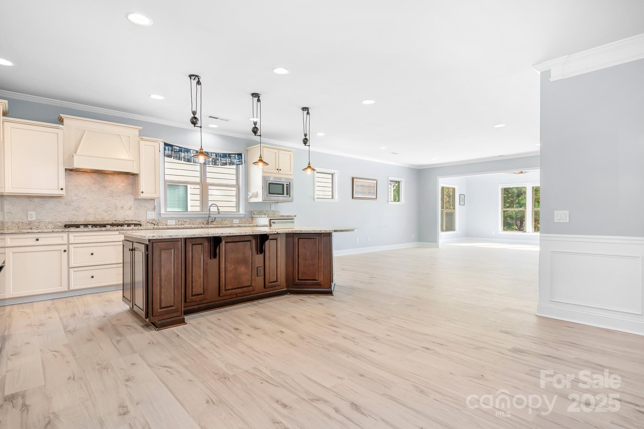 910 Kirby Drive Fort Mill, SC 29715 - Photo 6 of 30 a large kitchen with stainless steel appliances kitchen island granite countertop a stove a sink and white cabinets