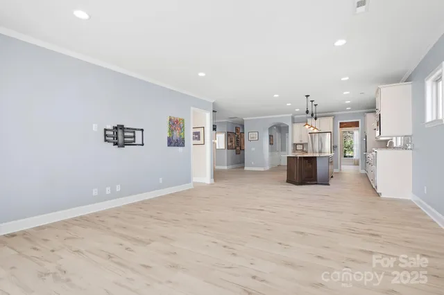a view of kitchen with refrigerator and window
