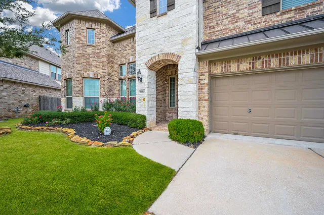 a view of a house with brick walls