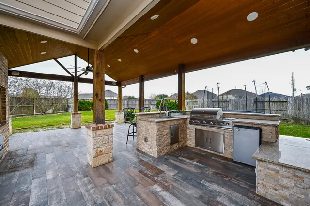 a view of a living room and kitchen with a large tree