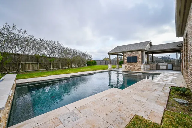 a view of swimming pool with a yard and sitting area