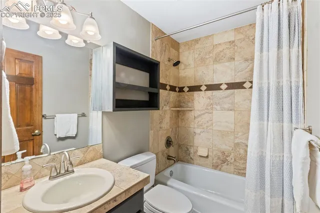 a bathroom with a sink toilet a mirror and shower