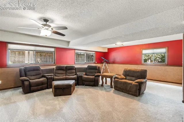 a living room with furniture a ceiling fan and a window