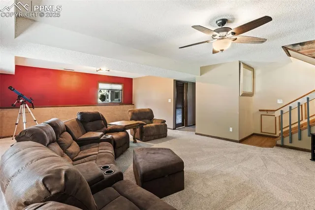 a living room with furniture and a ceiling fan