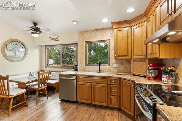 a kitchen with a sink appliances cabinets and furniture